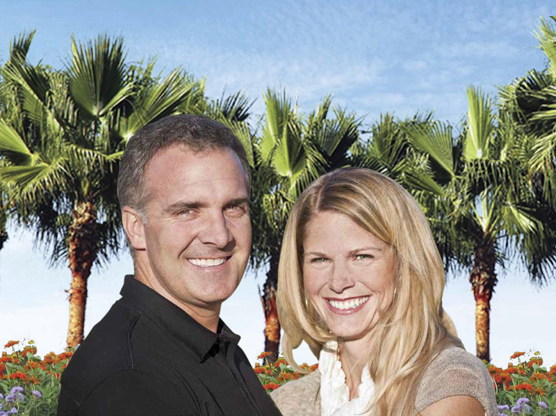 Couple smiling in from of palm trees